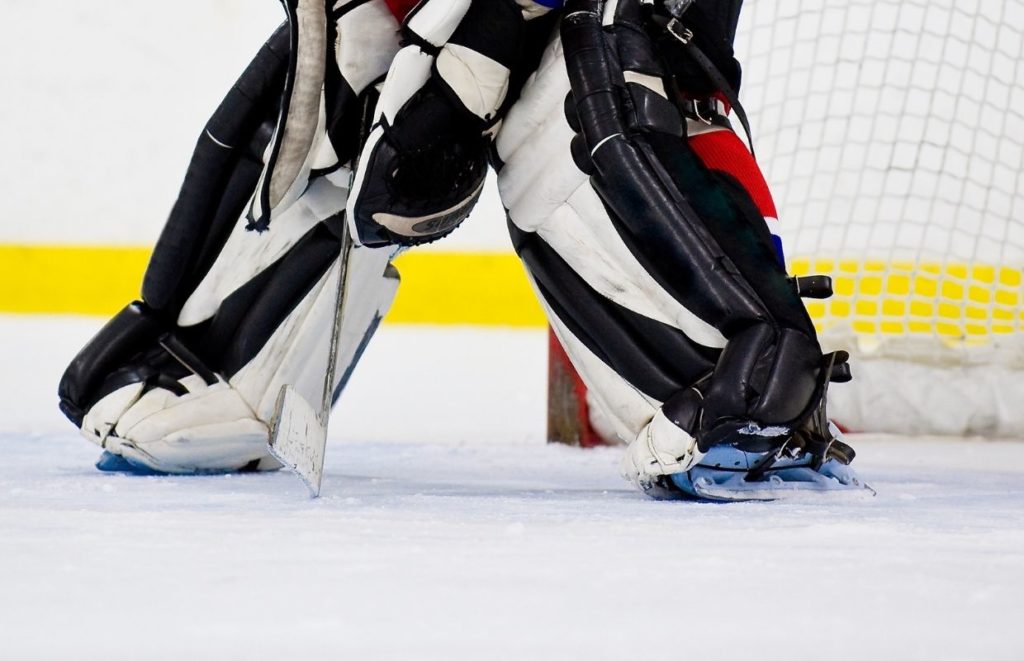 A close up of some goalie wearing skates